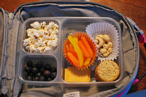 Popcorn, Carrots and Yellow Bell Pepper strips, raw cashews, cheese and crackers, blueberries